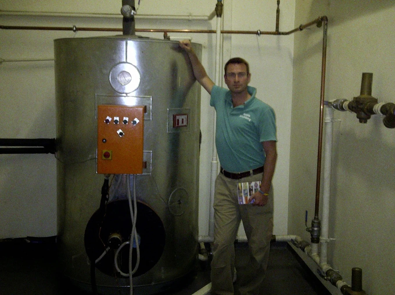 Garth Blair standing beside a commercial hot water cylinder in Johannesburg