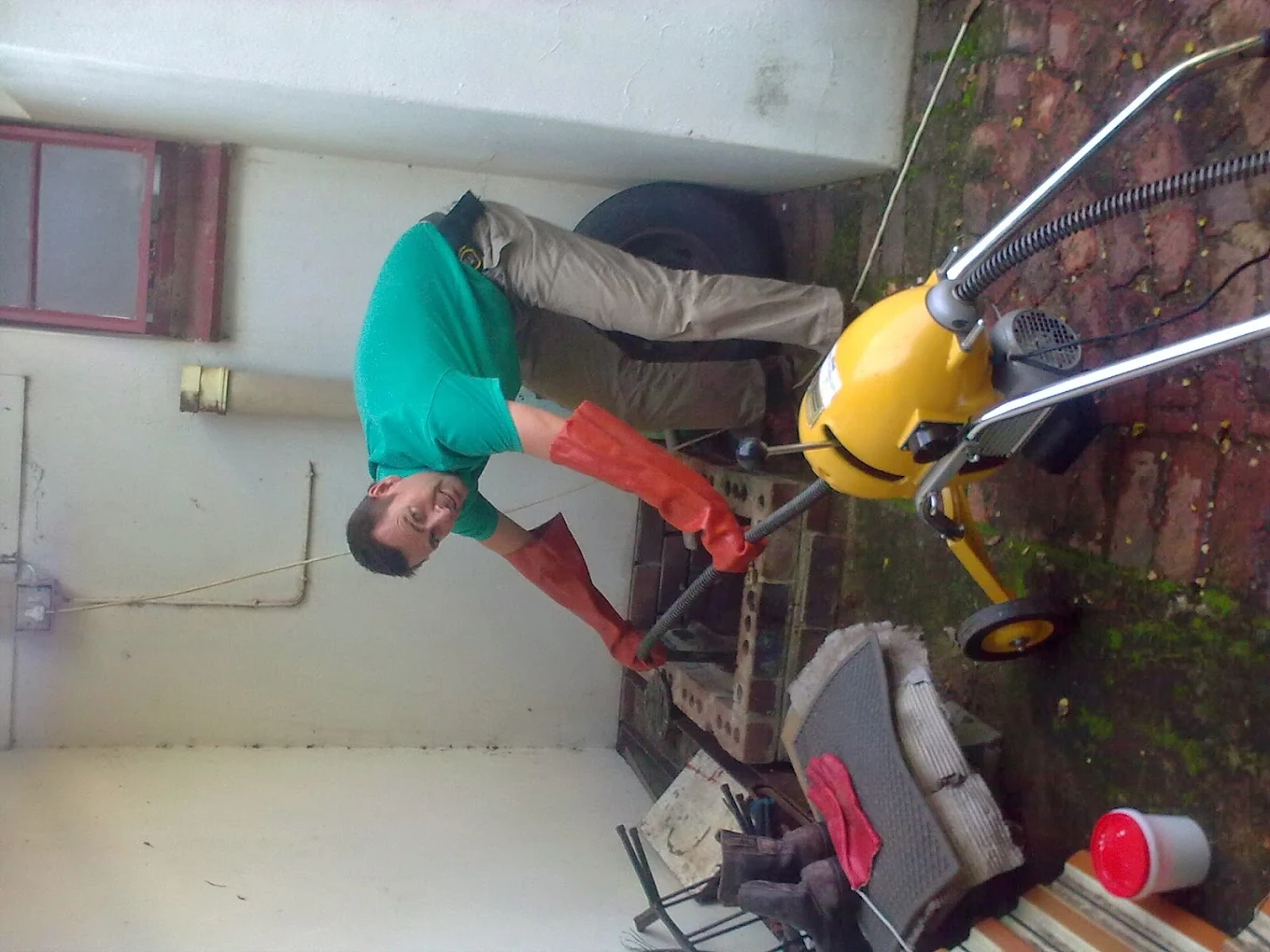 Plumber operating an electric drain cleaning machine on a Sandton property