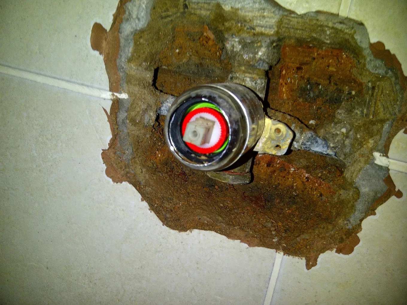 Repaired hidden water leak inside a tiled bathroom wall