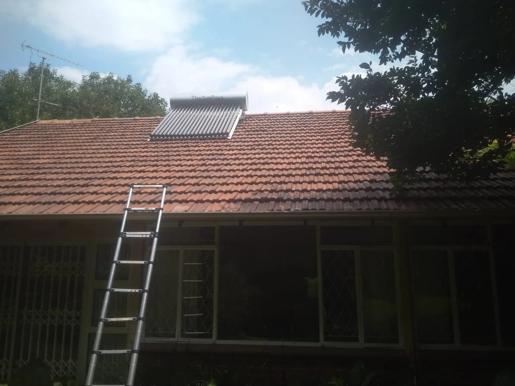 Evacuated tube solar geyser installed on a residential tile roof